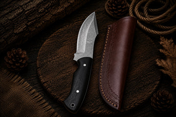 Damascus fixed blade hunter knife with dark wood handle and brown leather sheath