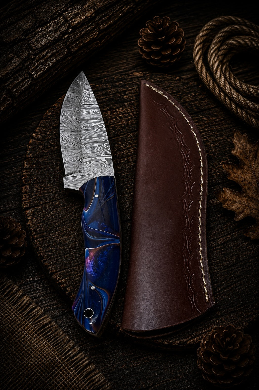 Damascus fixed blade knife with blue swirl resin handle and brown leather sheath