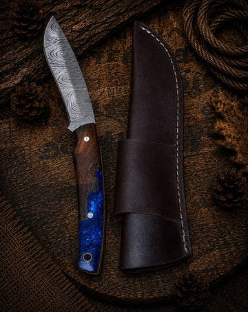 Damascus fixed blade knife with walnut wood and blue resin handle and dark leather sheath