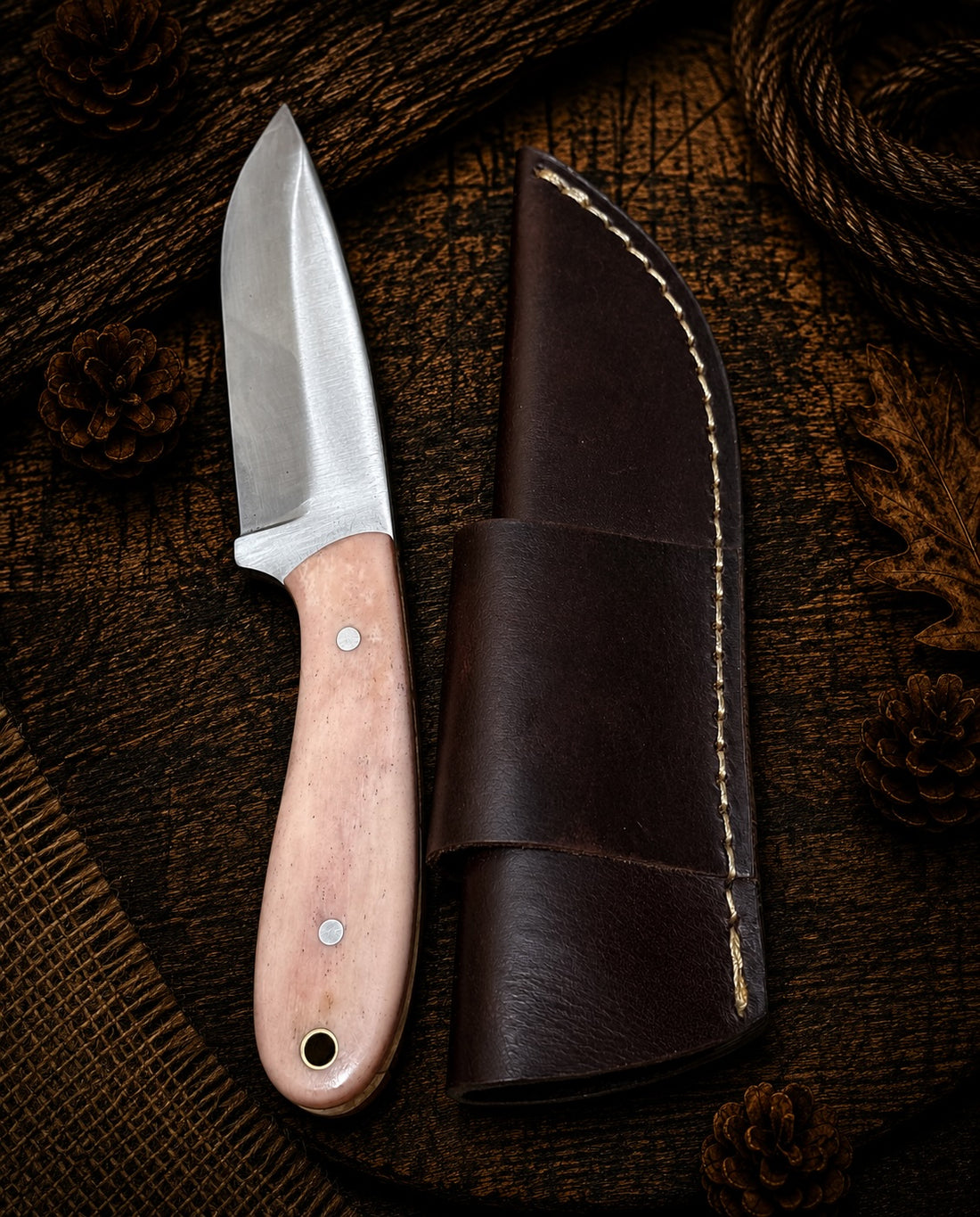 Fixed blade hunting knife with natural light wood handle and dark brown leather sheath