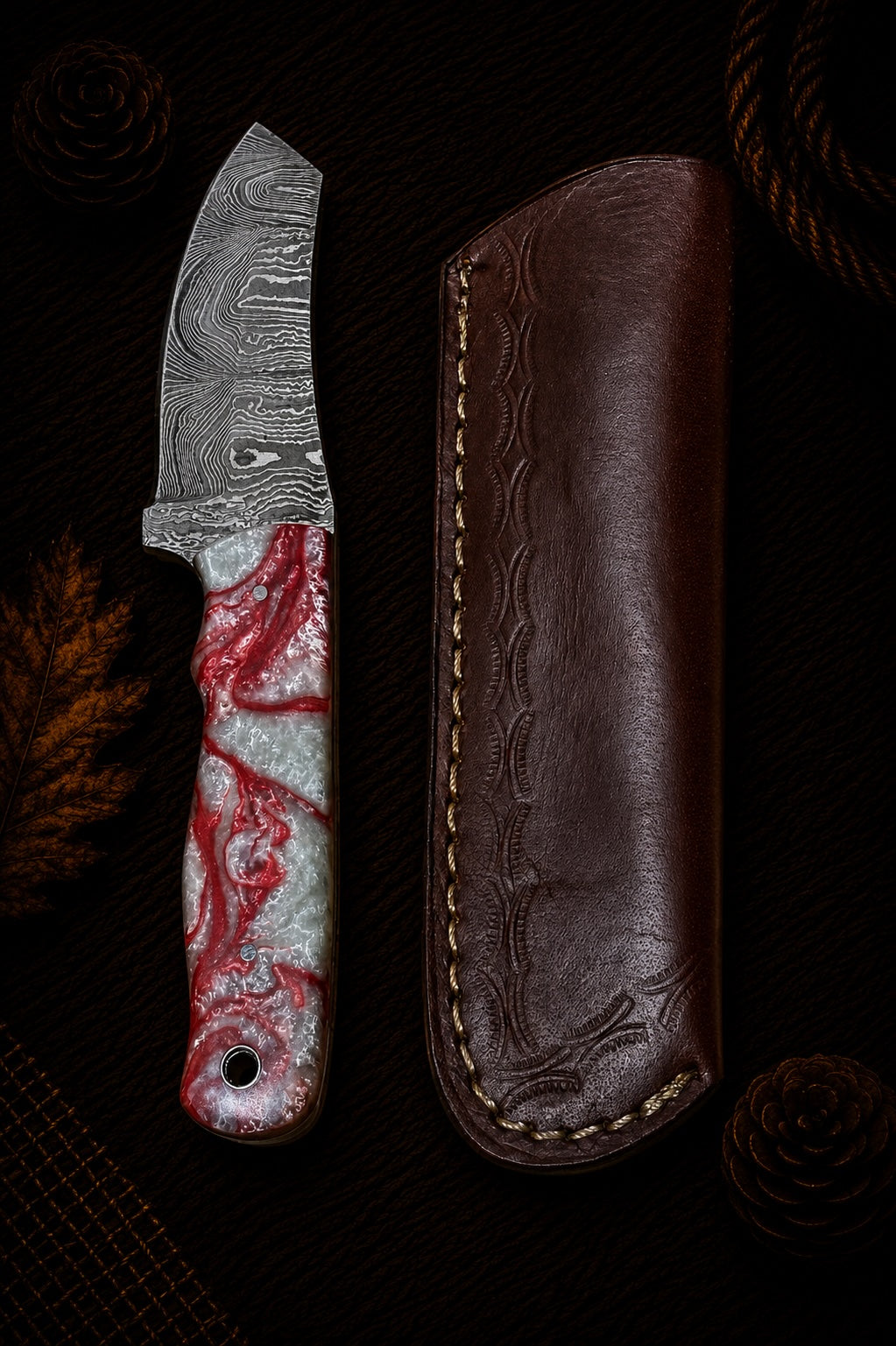 Damascus tanto fixed blade knife with red and white swirl resin handle and embossed leather sheath